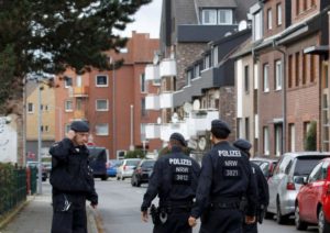 Police stand guard outside as officers investigate a residential building where arrested suspects linked to Paris attacks are thought to live, in Alsdorf near Aachen, Germany November 17, 2015. German police in the western city of Aachen arrested five people, at least three of them foreign citizens, on Tuesday in an operation linked to the attacks last Friday in Paris which killed at least 129 people. A special police response unit overpowered two women and one man outside a job centre in Alsdorf, a small town near Aachen in the state of North Rhine-Westphalia which is close to Germany's border with Belgium and the Netherlands. REUTERS/Ina Fassbender