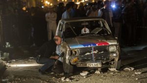 Egyptian police inspect a damaged car after a bomb exploded in the centre of the Egyptian capital Cairo late on October 14, 2014, wounding 13 people, security and medical officials said. A police officer on the scene told AFP the explosive device was placed near the entrance of a metro station close to the court house, apparently targeting policemen standing guard. AFP PHOTO / KHALED DESOUKI (Photo credit should read KHALED DESOUKI/AFP/Getty Images)